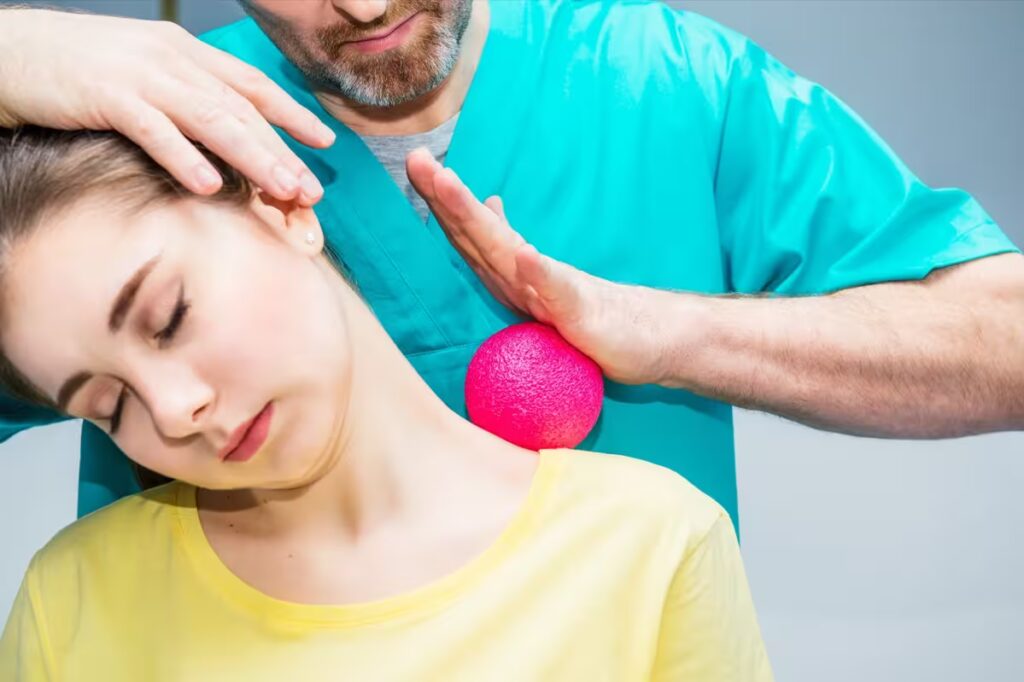 woman at the physiotherapy receiving ball massage converted